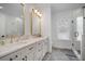 Elegant bathroom with double vanity, marble countertops and gold fixtures at 3011 Harbor View, Tampa, FL 33611