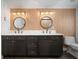 Stylish bathroom with double sinks, sleek countertops, dark wood cabinets, and modern lighting at 3011 Harbor View, Tampa, FL 33611