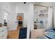 Cozy bedroom featuring wood floors, a canopy bed, white walls and a work area at 3011 Harbor View, Tampa, FL 33611