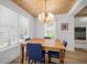 Bright dining room with a view, wood table, stylish chandelier, and large windows for natural light at 3011 Harbor View, Tampa, FL 33611