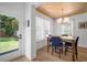Bright dining room with a view, wood table, stylish chandelier, and large windows for natural light at 3011 Harbor View, Tampa, FL 33611