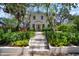 Inviting two-story home with a patterned walkway leading to a beautiful front yard with mature trees at 3011 Harbor View, Tampa, FL 33611