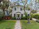 Charming two-story home with inviting walkway, lush landscaping, and well-manicured front yard at 3011 Harbor View, Tampa, FL 33611