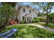 Two-story home with lush front yard and swing adds a playful touch to this inviting property at 3011 Harbor View, Tampa, FL 33611