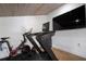 Modern gym equipped with a treadmill, exercise bike, and mounted TVs, great for home workouts at 3011 Harbor View, Tampa, FL 33611