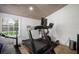 Bright gym features a treadmill, bike, wood ceiling, and shiplap walls for a modern workout space at 3011 Harbor View, Tampa, FL 33611