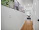 Hallway with hardwood floors and art leading to a bright, inviting room at 3011 Harbor View, Tampa, FL 33611