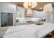 Bright kitchen with custom cabinets, large island with marble countertop, and stylish pendant lighting at 3011 Harbor View, Tampa, FL 33611