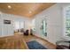 Bright living room with hardwood floors, wood plank ceiling, and ample natural light creates a cozy ambiance at 3011 Harbor View, Tampa, FL 33611