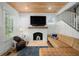 Cozy living room features a brick fireplace, hardwood floors, wood plank ceiling, and comfortable seating at 3011 Harbor View, Tampa, FL 33611