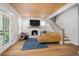 Bright living room with hardwood floors, wood plank ceiling, fireplace and cozy seating arrangement at 3011 Harbor View, Tampa, FL 33611