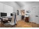 Bright home office with modern desk, ample workspace, wood floors, and adjacent bathroom at 3011 Harbor View, Tampa, FL 33611