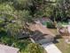 Inviting single-Gathering home featuring a screened pool, garage and driveway, and lush landscaping at 3205 Coventry N, Safety Harbor, FL 34695