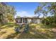 Backyard view with a screened patio and outdoor seating area for relaxation at 3205 Coventry N, Safety Harbor, FL 34695