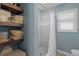 Bathroom shower with white tiling, floating shelves and a window at 3205 Coventry N, Safety Harbor, FL 34695