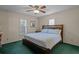 Bedroom with a bed, ceiling fan, carpet, and windows for natural light at 3205 Coventry N, Safety Harbor, FL 34695