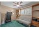 Cozy bedroom with custom built-in shelves, a futon sofa, and a large window at 3205 Coventry N, Safety Harbor, FL 34695