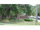 Entrance sign for Safety Harbor, featuring brick columns, a black iron fence, and lush landscaping at 3205 Coventry N, Safety Harbor, FL 34695