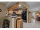 Kitchen with wood cabinets, breakfast bar, and black appliances at 3205 Coventry N, Safety Harbor, FL 34695