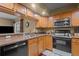 Kitchen featuring stainless steel appliances, oak cabinetry, and granite countertops at 3205 Coventry N, Safety Harbor, FL 34695