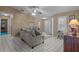 Comfortable living room featuring tile floors, a ceiling fan, and lots of natural light at 3205 Coventry N, Safety Harbor, FL 34695