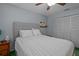 Peaceful bedroom with a ceiling fan, closet, large window, and a comfortable bed at 3205 Coventry N, Safety Harbor, FL 34695