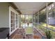 Outdoor patio with screened walls and a dining table set at 3205 Coventry N, Safety Harbor, FL 34695