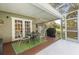 The screened-in patio has a table with chairs and a grill perfect for outdoor entertaining at 3205 Coventry N, Safety Harbor, FL 34695