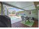 Enclosed back patio with a dining set, view of the pool and landscaping at 3205 Coventry N, Safety Harbor, FL 34695