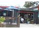 Outdoor dining area with umbrella-shaded tables at the Whistle Stop Grill & Bar at 3205 Coventry N, Safety Harbor, FL 34695
