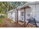 Back entrance to the home with grill and outdoor access at 3310 W Ballast Point Blvd, Tampa, FL 33611