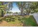 Spacious backyard area featuring mature trees, playset and a privacy fence at 3310 W Ballast Point Blvd, Tampa, FL 33611