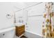 Bathroom with a modern wood vanity, toilet, and tub with shower featuring a floral curtain at 3310 W Ballast Point Blvd, Tampa, FL 33611