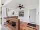 Inviting front porch featuring terra cotta tile flooring, rustic wooden bar, and ceiling fan at 3310 W Ballast Point Blvd, Tampa, FL 33611