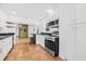 Bright kitchen featuring stainless steel appliances, breakfast bar, and view of dining area at 3310 W Ballast Point Blvd, Tampa, FL 33611