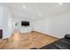 Bright living room featuring tile floors, a television, and a white cabinet at 3310 W Ballast Point Blvd, Tampa, FL 33611