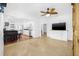Open-concept living area featuring tile flooring, ceiling fan, and seamless flow into kitchen at 3310 W Ballast Point Blvd, Tampa, FL 33611