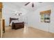 Spacious main bedroom featuring multiple ceiling fans, a bed, a chest, and access to the backyard at 3310 W Ballast Point Blvd, Tampa, FL 33611