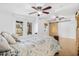 Close up view of the spacious main bedroom featuring multiple ceiling fans and access to the backyard at 3310 W Ballast Point Blvd, Tampa, FL 33611