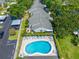 Aerial view of well-kept community features pool, assigned parking, and lush green landscaping at 3447 Killdeer Pl, Palm Harbor, FL 34685