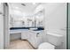 Bathroom featuring a sink with unique mirror design, toilet, and white vanity with storage at 3447 Killdeer Pl, Palm Harbor, FL 34685