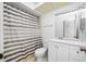 Bathroom featuring a shower with striped shower curtain, white vanity, and toilet at 3447 Killdeer Pl, Palm Harbor, FL 34685