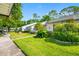 Neat white homes with well-kept lawns and lush landscaping create a welcoming atmosphere at 3447 Killdeer Pl, Palm Harbor, FL 34685