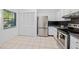 Modern kitchen with stainless steel appliances and white cabinetry at 3447 Killdeer Pl, Palm Harbor, FL 34685