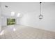 Open-concept living area with tile flooring and a modern light fixture at 3447 Killdeer Pl, Palm Harbor, FL 34685