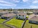 Expansive aerial view of a home with a large, grassy backyard and a community lake in the background at 3739 Capri Coast Dr, Plant City, FL 33565