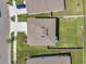 Aerial view of a well-maintained home with a manicured lawn, driveway, and neighborhood street at 3739 Capri Coast Dr, Plant City, FL 33565