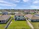 Aerial view of a home's backyard featuring a green lawn, a fence, and a view of the neighborhood at 3739 Capri Coast Dr, Plant City, FL 33565