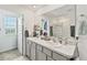 Bright bathroom featuring a double sink vanity, decorative shower curtain, and tiled floors at 3739 Capri Coast Dr, Plant City, FL 33565