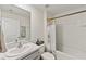 A well-lit bathroom featuring a sink vanity, a toilet, and a shower with a decorative curtain at 3739 Capri Coast Dr, Plant City, FL 33565